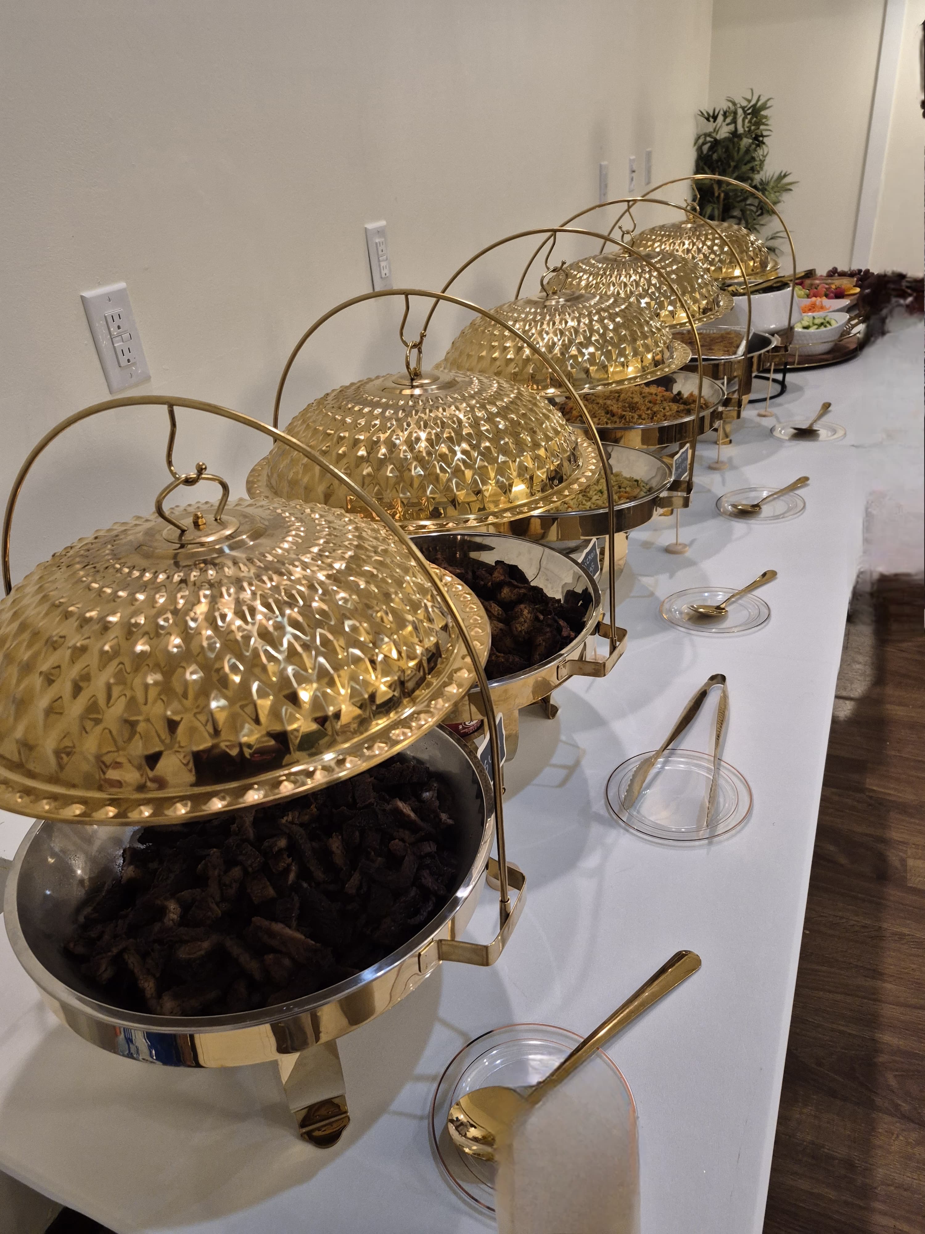 Professional buffet setup with golden chafing dishes