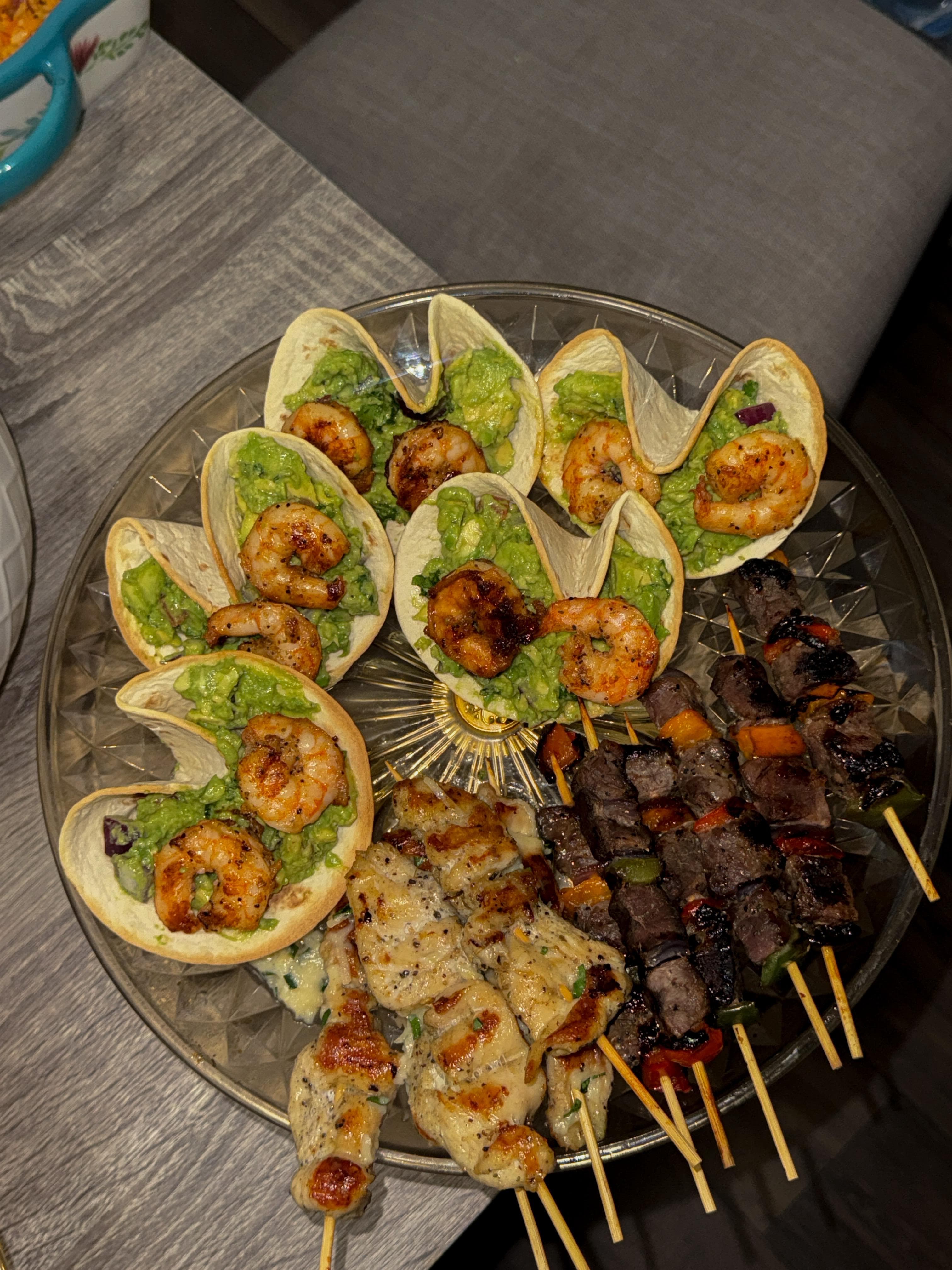 Shrimp tacos with guacamole and grilled skewers