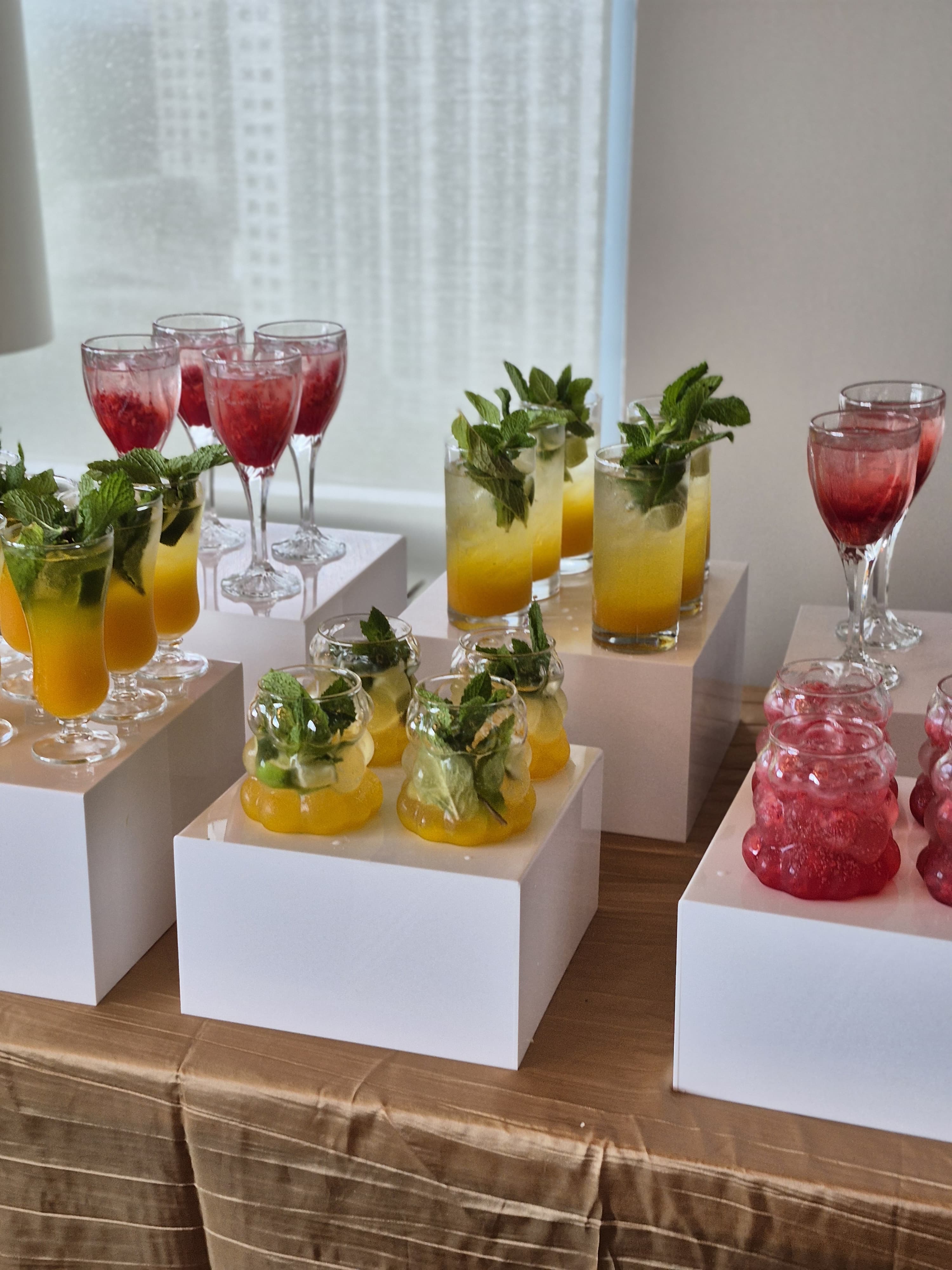 Colorful signature cocktails and mocktails with fresh mint garnish