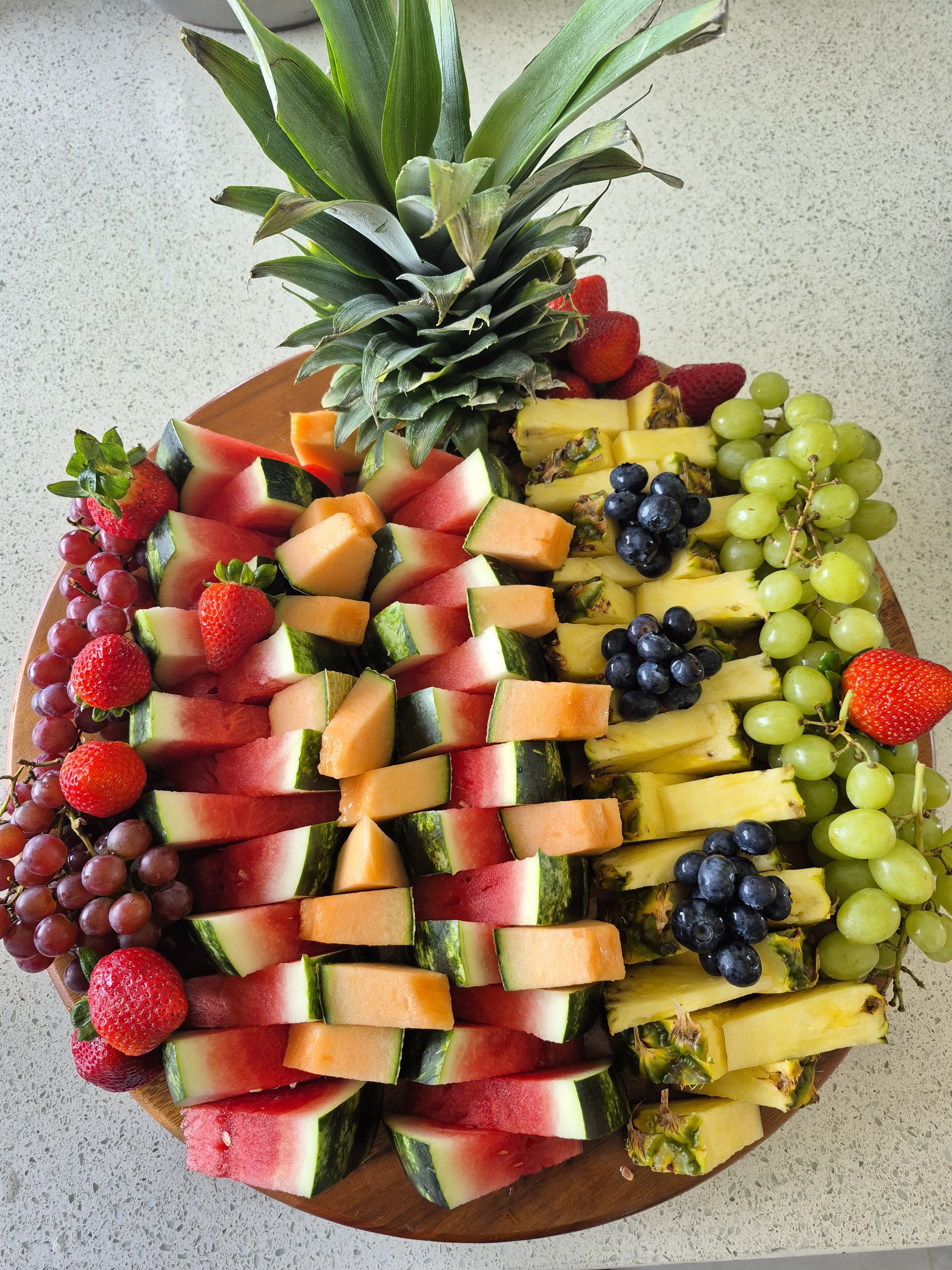 Tropical fruit platter with pineapple, watermelon, and grapes